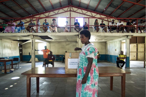 A resident casts her vote at a polling station
